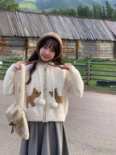 Gemütliche Strickjacke mit Pom-Pom-Welpen